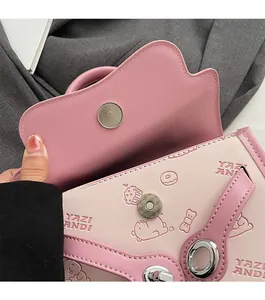 Detailed view of pink embossed handbag featuring cute patterns and a magnetic snap closure
