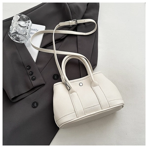 Close-up of white lychee pattern leather texture with silver metal buckle detail