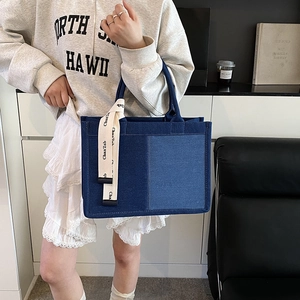 Large blue denim patchwork tote bag with stylish side strap and spacious design