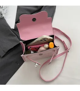 Pink mini crossbody bag interior showing storage space for phone and makeup accessories