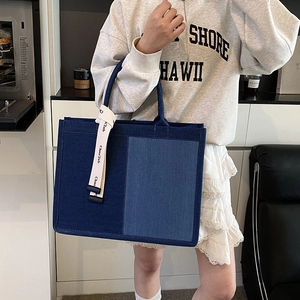 Large blue patchwork denim tote bag with decorative strap for casual daily commuting