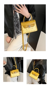 Detail of yellow vintage crossbody bag with cartoon bear print and secure metal clasp