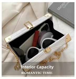 Internal capacity of white croc-embossed box bag showing space for daily essentials