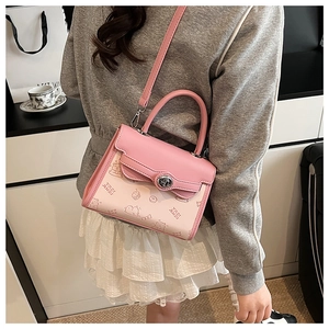 Detailed view of crossbody bag with pink gradient pattern and cartoon bear print
