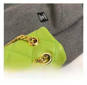 Detailed close-up of golden hardware and chain strap on neon green quilted leather bag