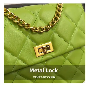 Close-up of golden hardware lock and quilted leather texture on green chain bag