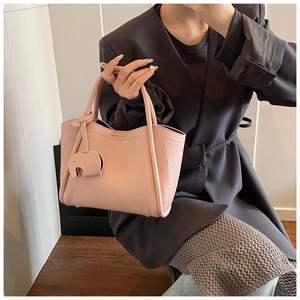 Pink pebbled leather bucket bag featuring a cute elephant charm and BEAR&BOY brand logo