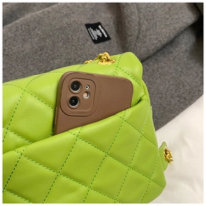 Detail view of the back pocket on the neon green quilted bag with gold chain strap