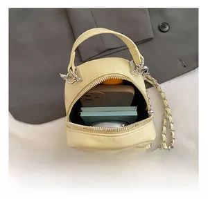 Detail view of the pale yellow quilted bag showing its interior capacity and daily essentials