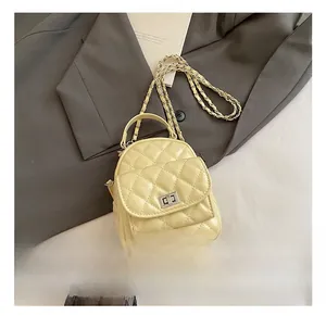 Close-up of diamond quilted mini backpack with silver twist lock and chain strap