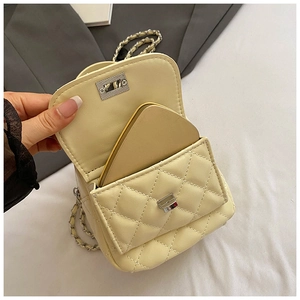 Detail of cream quilted mini backpack with silver twist lock and gold mirror inside