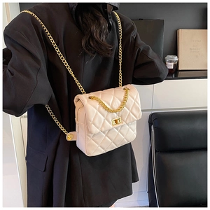 Rear view of cream quilted chain bag worn as a stylish backpack for daily use