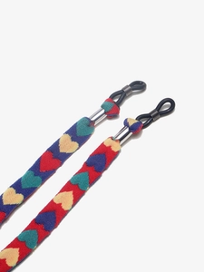 Detail of colorful woven eyeglass strap with heart patterns and silicone loops