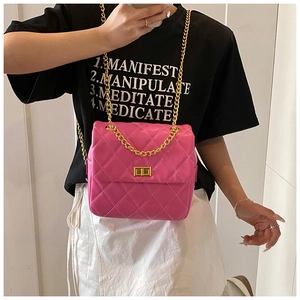 Detail of rose pink quilted crossbody bag with gold chain strap and metallic swivel lock