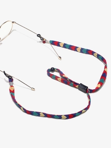 Detail of colorful woven eyewear chain with red, yellow, green, and blue heart patterns