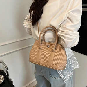 Minimalist beige pleated bucket bag with long strap and metallic snap for women