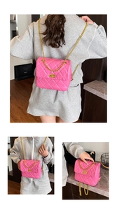 Detail showing pink quilted chain bag with gold metal clasp and versatile straps