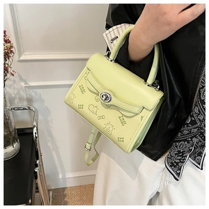 Detail of mint green PU leather bag with cute embossed bear pattern and silver twist lock