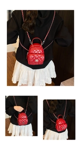 Detailed view of red quilted backpack with elegant chain straps and diamond pattern