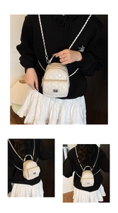 Detail of cream quilted mini backpack with metallic chain straps and twist lock closure