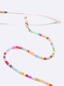 Colorful beaded eyewear strap with colorful shell beads and golden lobster clasps on white
