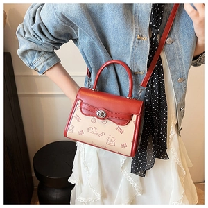 Fashionable beige and red small square bag featuring cartoon bear prints and metal lock