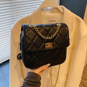 Quilted black leather backpack with gold chain strap and metallic twist lock closure