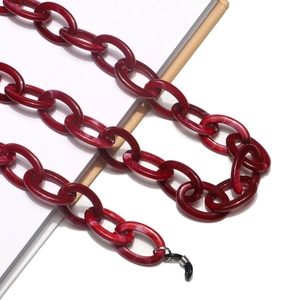 Detail of dark red acrylic chain with marble texture and black rubber end loops