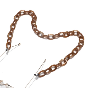 Detail of tortoise shell acrylic eyeglass chain with black anti-slip rubber loops