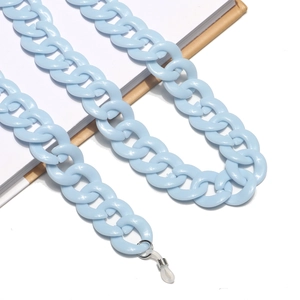 Detail of light blue acrylic resin eyeglass chain with silicone loops on notebook