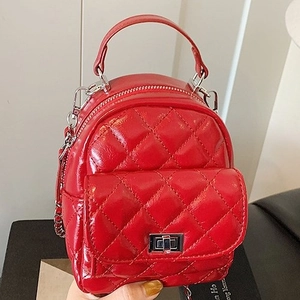 Glossy red quilted mini backpack with silver twist lock and metal chain straps