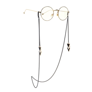Round gold frame glasses with black metal chain and geometric lightning bolt pendants