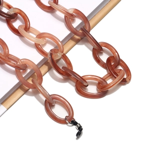 Detail view of large amber marble resin eyewear chain with black silicone connectors