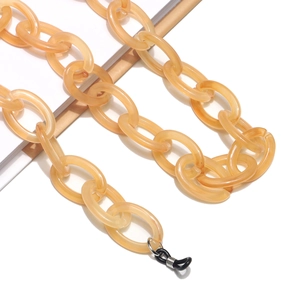 Close-up of amber resin eyeglass chain with tortoiseshell texture and rubber connectors