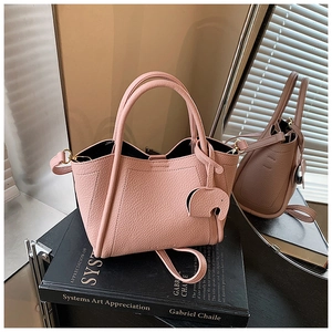 Pink lychee grain bucket bag with cute elephant charm and adjustable shoulder strap