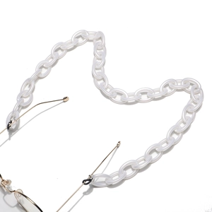 Close-up of white acrylic chain eyewear strap with rubber loop and metal detail