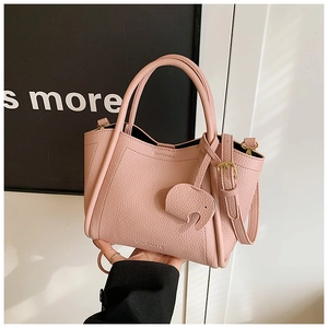 Pink bucket bag with lychee texture featuring a cute elephant charm and adjustable strap