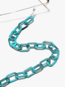 Macro detail of turquoise acrylic eyewear chain with bold oval links and marble texture