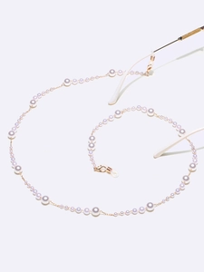 Close-up of elegant gradient pearl eyewear chain with golden lobster clasps and silicone loops