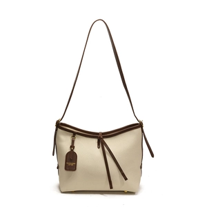 Sac fourre-tout minimaliste en cuir beige avec anses marron pour les trajets quotidiens