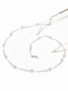 Detail view of pearl eyewear chain featuring gradient sized beads and silicone loops