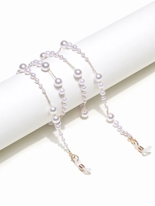 Detail of gradient pearls on a gold chain with glasses loops and lobster clasps