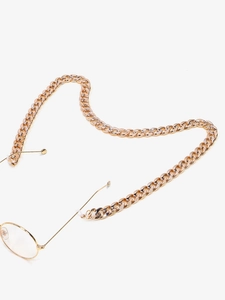 Detailed view of shiny gold Cuban link eyewear chain with non-slip silicone connectors