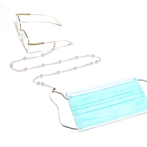 Handmade gradient pearl chain for glasses and masks with golden metal clasps on white background