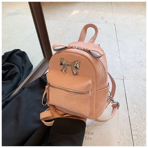 Détail du mini sac à dos rose en cuir PU avec nœud métallique et poignée supérieure
