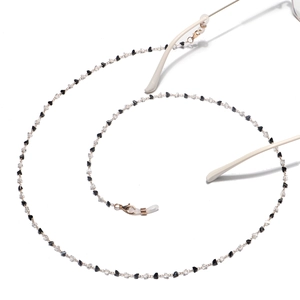 Gold chain glasses strap featuring black and white crystals with white silicone loops