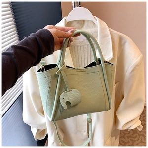 Mint green pebble leather tote bag with elephant charm and CHERRMATE logo detail