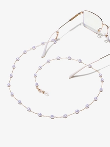 Detailed shot of golden eyewear chain featuring lavender faux pearls and rubber loop ends