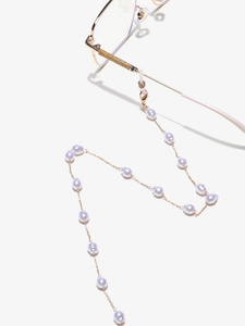Detail of golden glasses chain with white pearls, lobster clasp and rubber connectors