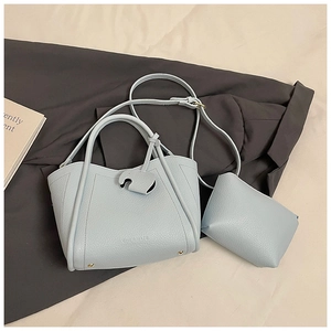Detail of light blue lychee pattern leather bucket bag with matching small pouch